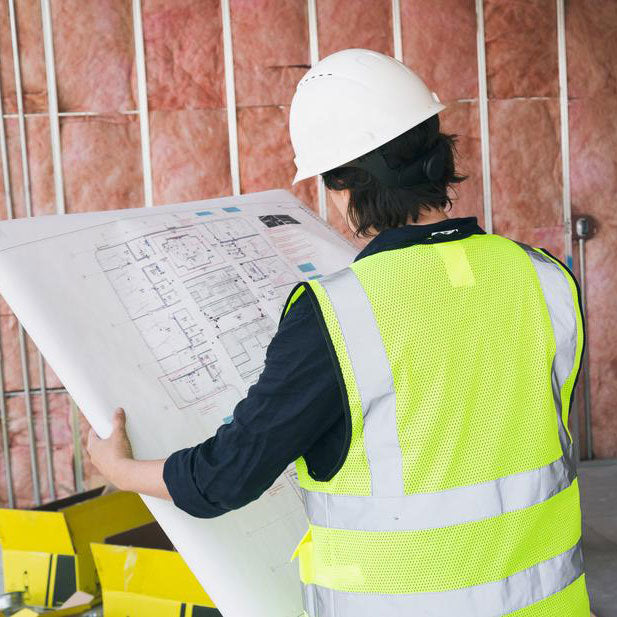 Builder holding a blueprint / Image by Shopify Partners Burst